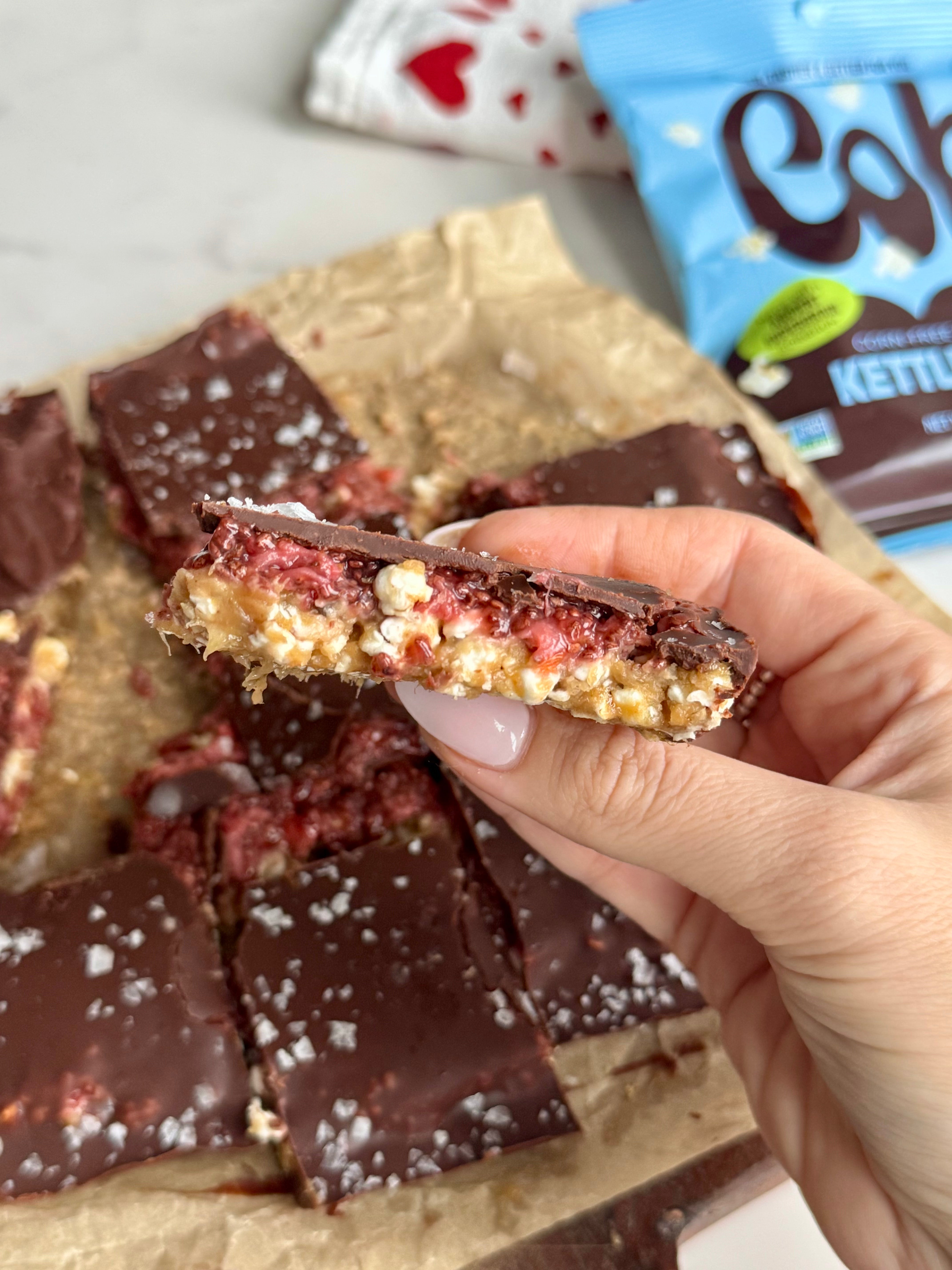 A woman's hand holding a homemade crispy chocolate bar