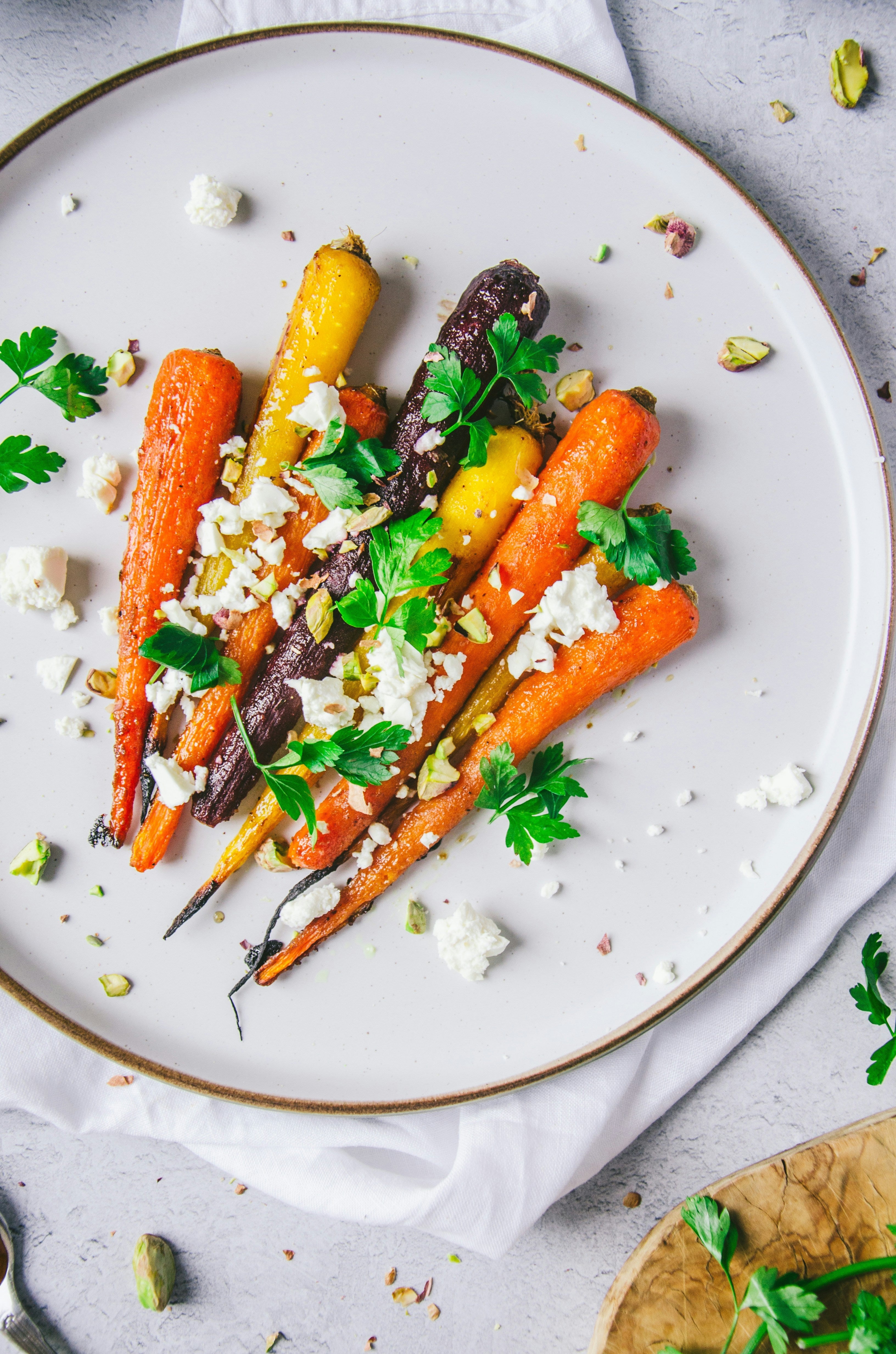 A plate of roasted carrots, topped with feta cheese