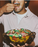 Man eating Cob chips from a big bowl